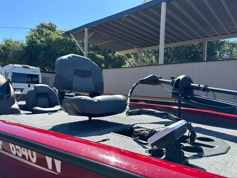 Slide: The Image of 2022 Tracker PRO TEAM 175 TWX boat with seating and equipment, parked outdoors. - 5