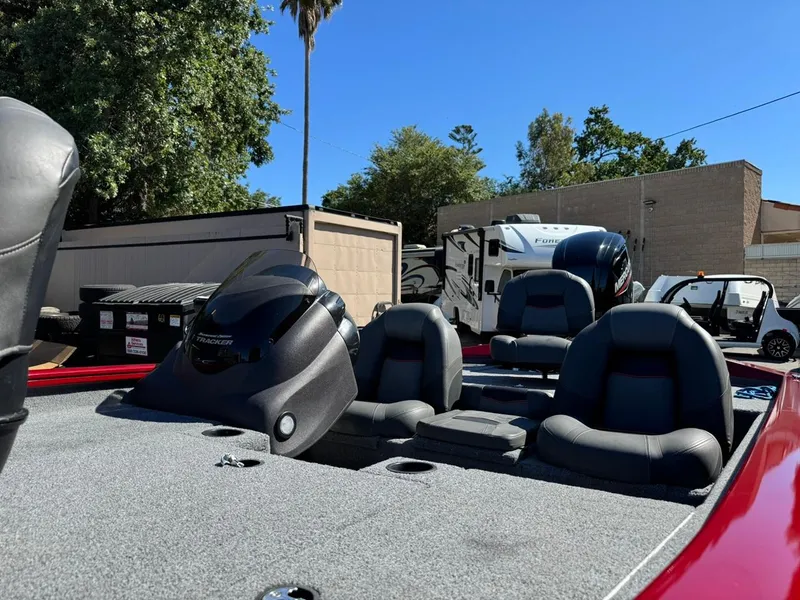 Slide: The Image of 2022 Tracker PRO TEAM 175 TWX boat with seating, parked outdoors. - 7