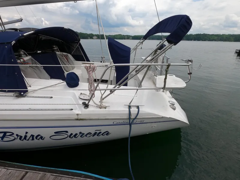 Slide: The Image of Catalina 42 MK11 sailboat docked on a lake, featuring blue covers and "Brisa Sureña" text. - 3