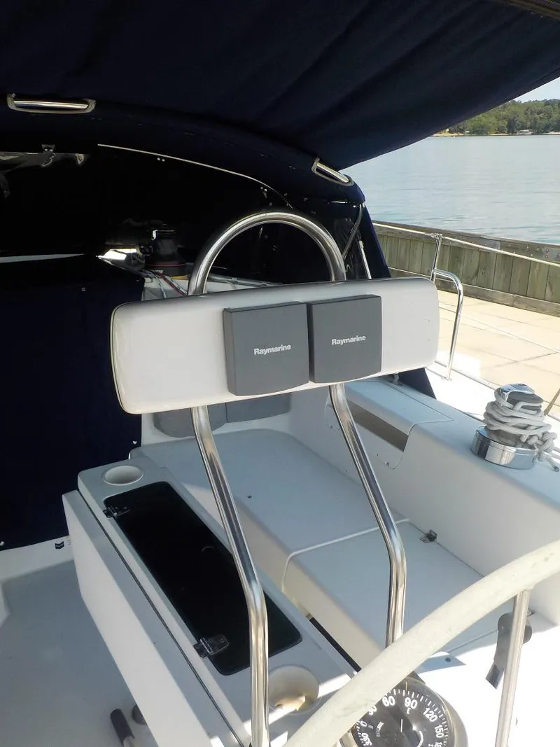 Slide: The Image of 2002 Catalina 42 MK11 yacht cockpit with dual Raymarine displays and stainless steel wheel. - 44