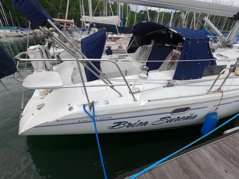 Slide: The Image of Catalina 42 MKII 2002 sailboat docked with blue covers and visible name "Brina Sureria". - 5