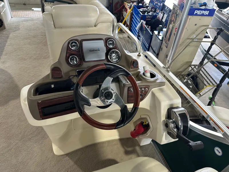 Slide: The Image of Steering console of 2011 Avalon 2585 Paradise Tri Toon boat with Garmin display. - 5