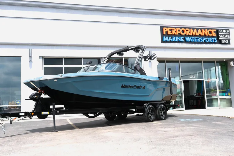 Slide: The Image of 2025 MasterCraft XT24 boat displayed at Performance Marine Watersports dealership. - 1