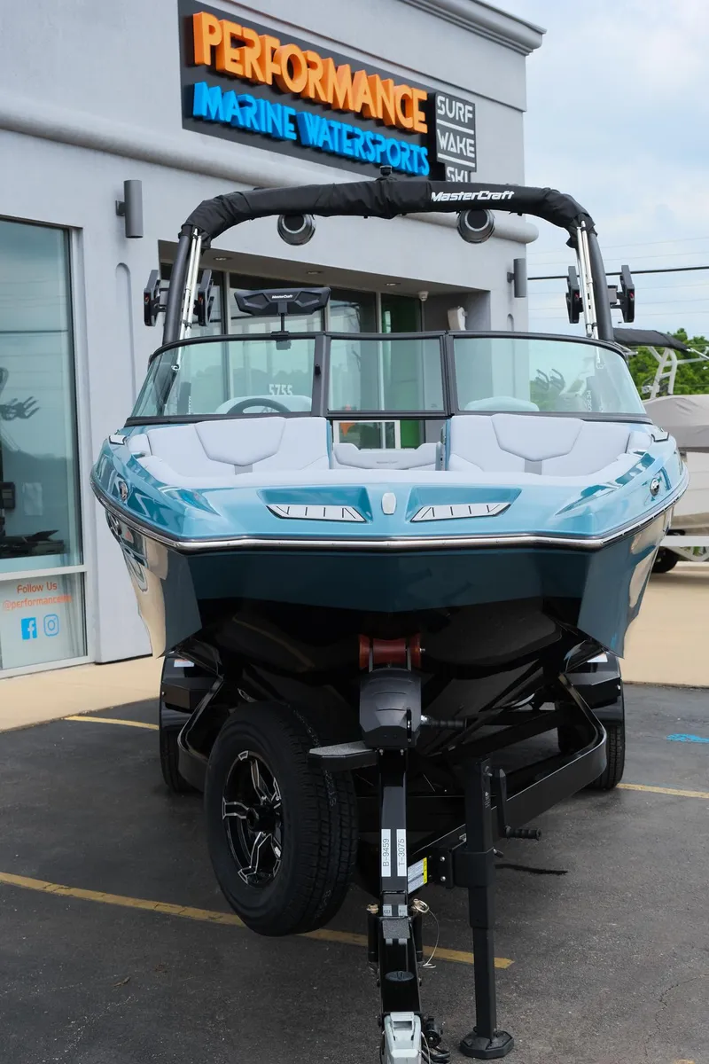 Slide: The Image of 2025 MasterCraft XT24 boat displayed at Performance Marine Watersports dealership. - 14