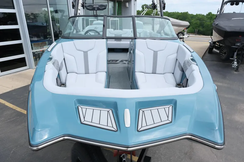 Slide: The Image of 2025 MasterCraft XT24 boat with sleek blue design and spacious seating. - 15