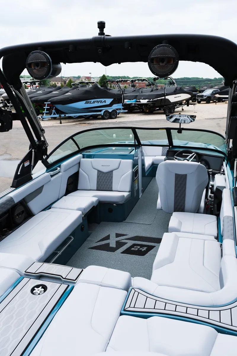 Slide: The Image of 2025 MasterCraft XT24 boat interior with sleek seating and modern design. - 17