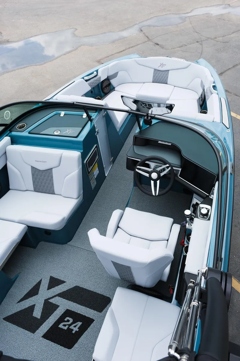 Slide: The Image of 2025 MasterCraft XT24 boat interior with modern seating and steering wheel design. - 19