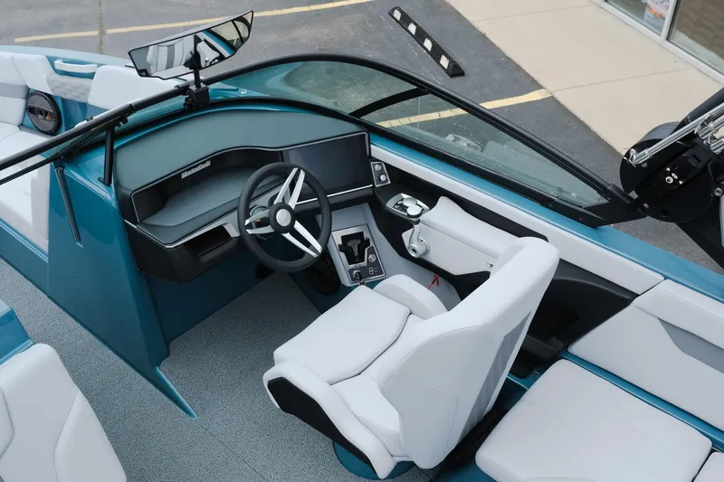 Slide: The Image of 2025 MasterCraft XT24 boat interior with modern dashboard and steering wheel. - 21