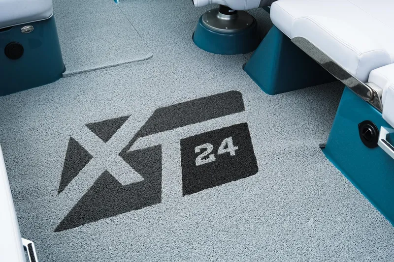 Slide: The Image of 2025 MasterCraft XT24 boat interior with logo on textured flooring. - 24