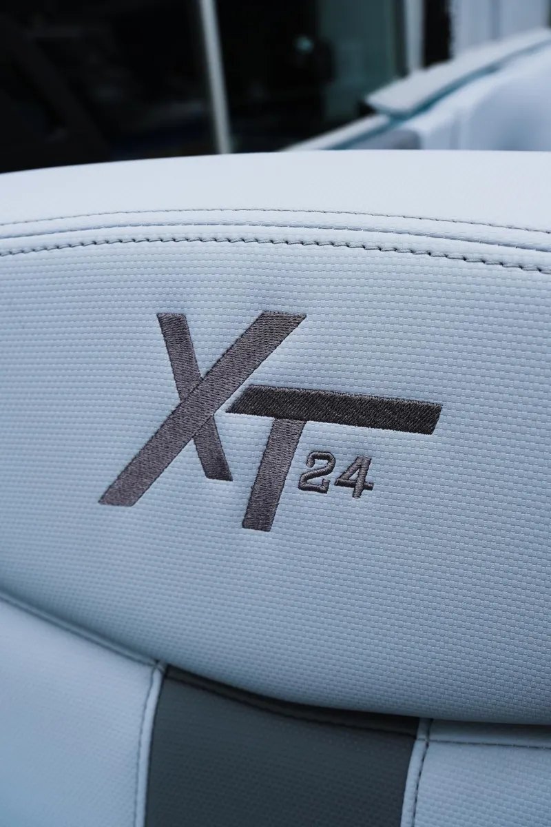Slide: The Image of 2025 MasterCraft XT24 boat seat with embroidered logo detail. - 29