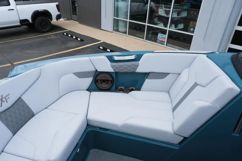 Slide: The Image of 2025 MasterCraft XT24 boat interior with white seating and modern design. - 34
