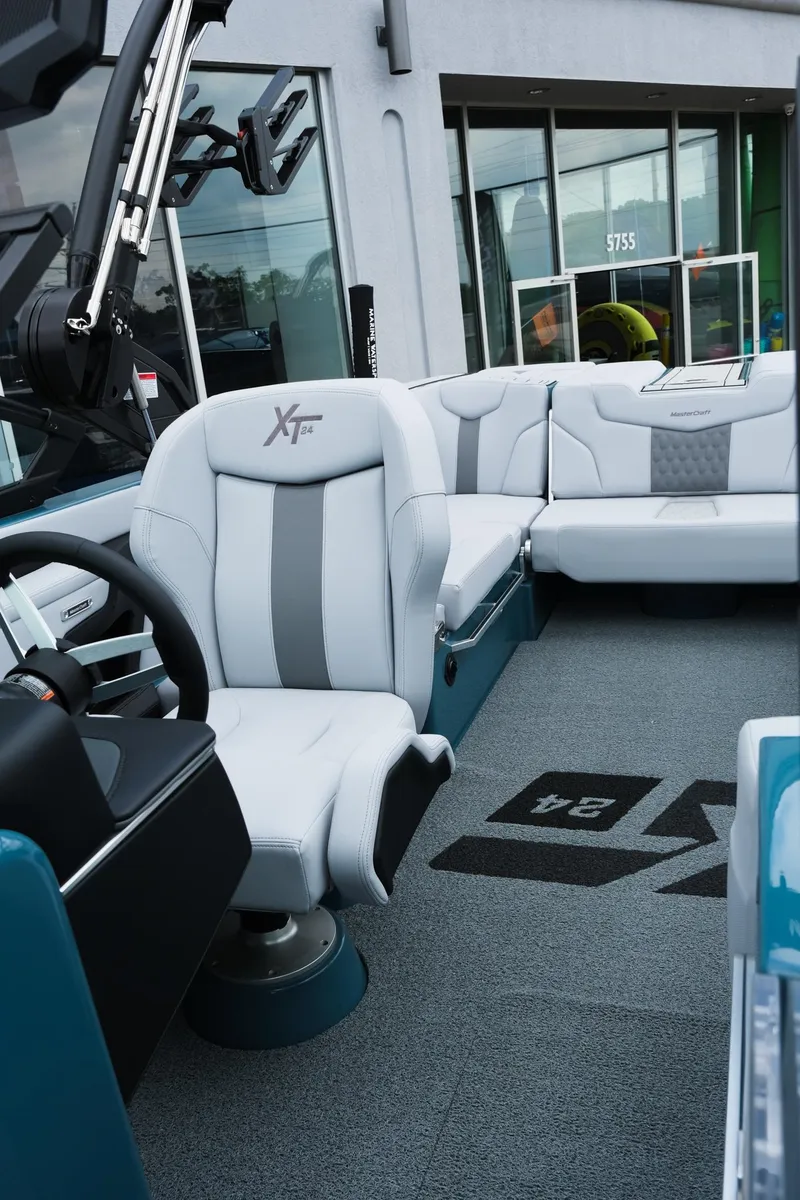 Slide: The Image of 2025 MasterCraft XT24 boat interior with modern seating and sleek design. - 35