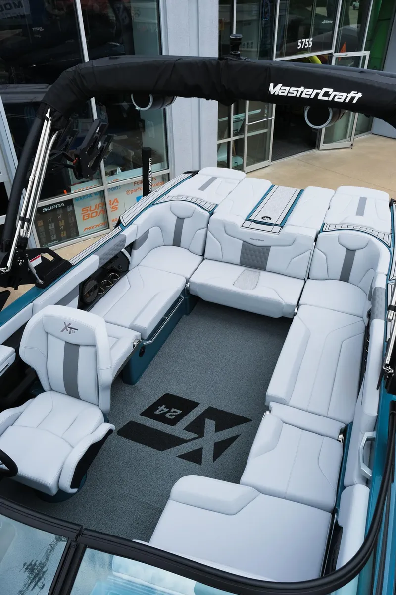 Slide: The Image of 2025 MasterCraft XT24 boat interior with spacious seating and modern design. - 36