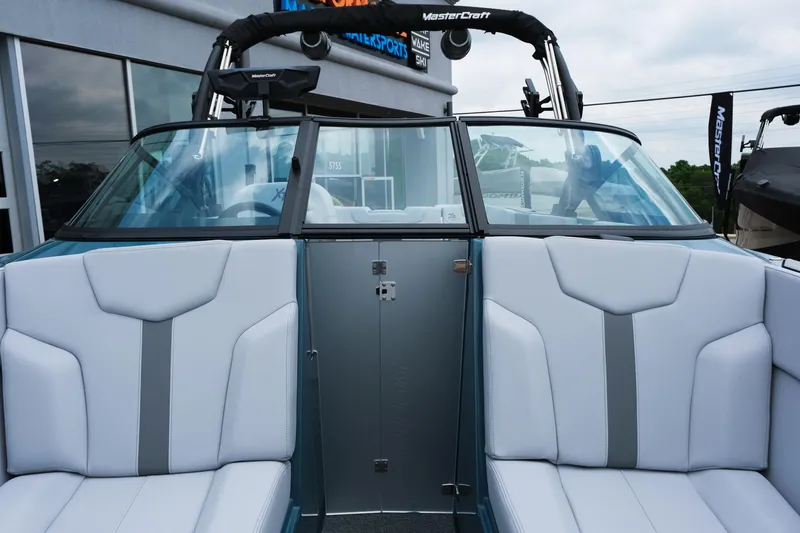 Slide: The Image of 2025 MasterCraft XT24 boat interior with white seating and sleek design. - 37