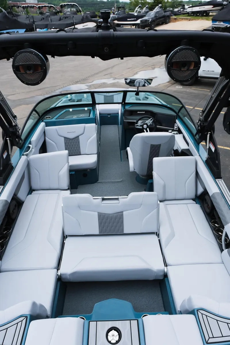Slide: The Image of 2025 MasterCraft XT24 boat interior with luxurious seating and modern design. - 38