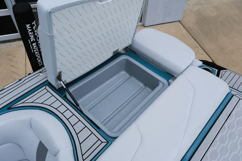 Slide: The Image of 2025 MasterCraft XT24 boat storage compartment with open lid, showcasing spacious interior. - 41