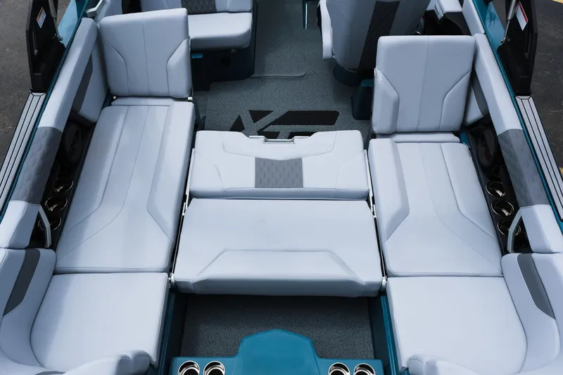Slide: The Image of 2025 MasterCraft XT24 boat interior with spacious, luxurious seating and modern design. - 42