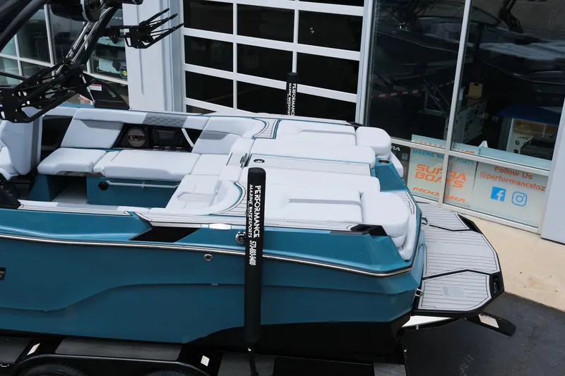 Slide: The Image of 2025 MasterCraft XT24 boat with sleek design and spacious seating, displayed outdoors. - 6