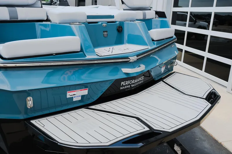 Slide: The Image of 2025 MasterCraft XT24 boat with sleek blue design and spacious swim platform. - 9