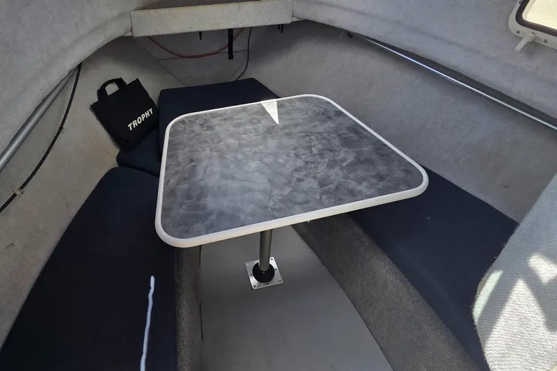 Slide: The Image of Interior of a 2007 Trophy 2002 Walkaround boat with a compact dining area. - 12
