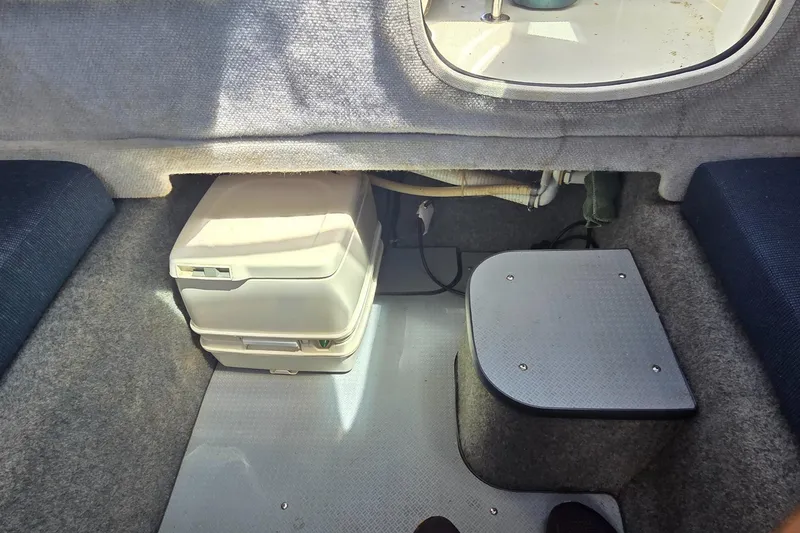 Slide: The Image of Interior of a 2007 Trophy 2002 Walkaround boat, featuring compact storage and seating. - 13