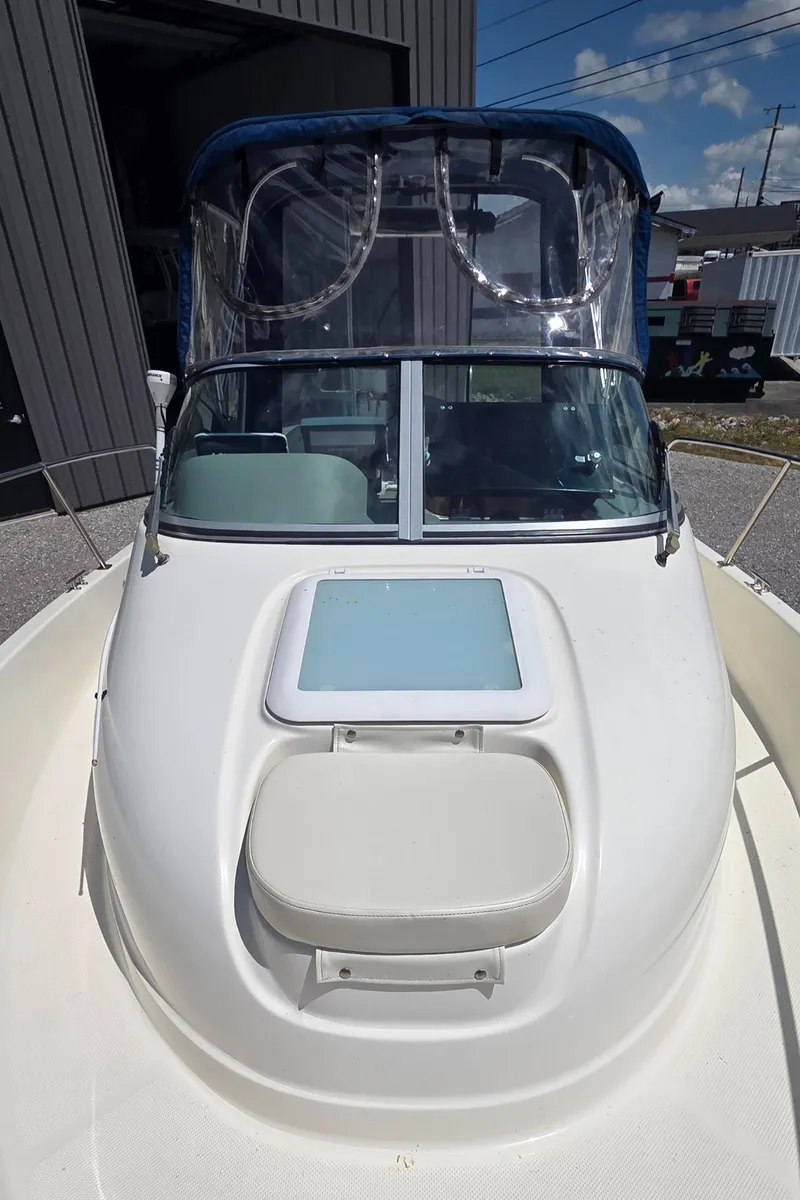 Slide: The Image of 2007 Trophy 2002 Walkaround boat with cabin, docked outdoors under clear skies. - 16