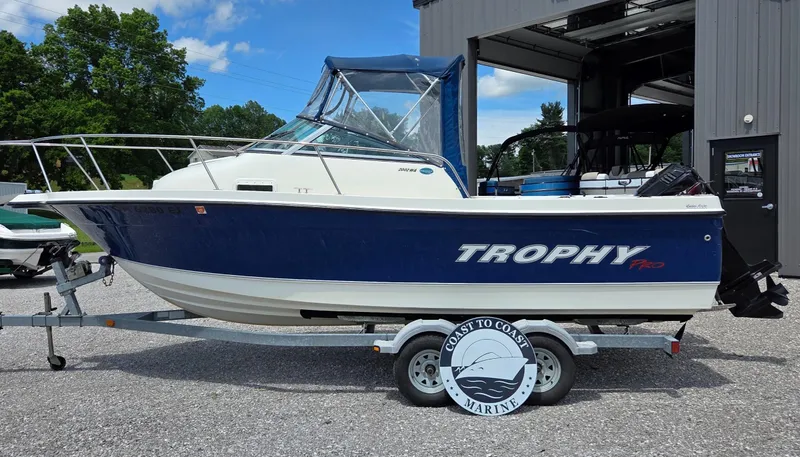 Slide: The Image of 2007 Trophy 2002 Walkaround boat on trailer, parked outdoors near a building. - 2