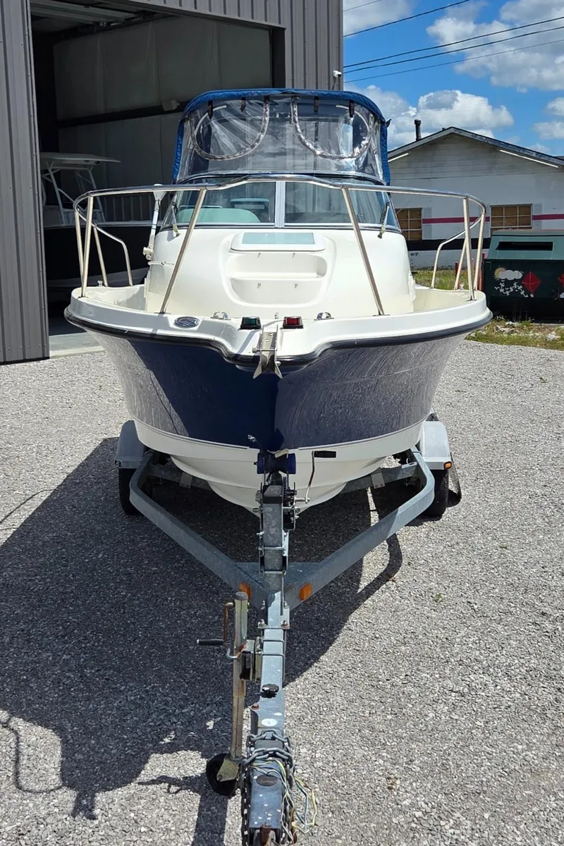 Slide: The Image of 2007 Trophy 2002 Walkaround boat on trailer, parked outdoors near a garage. - 3