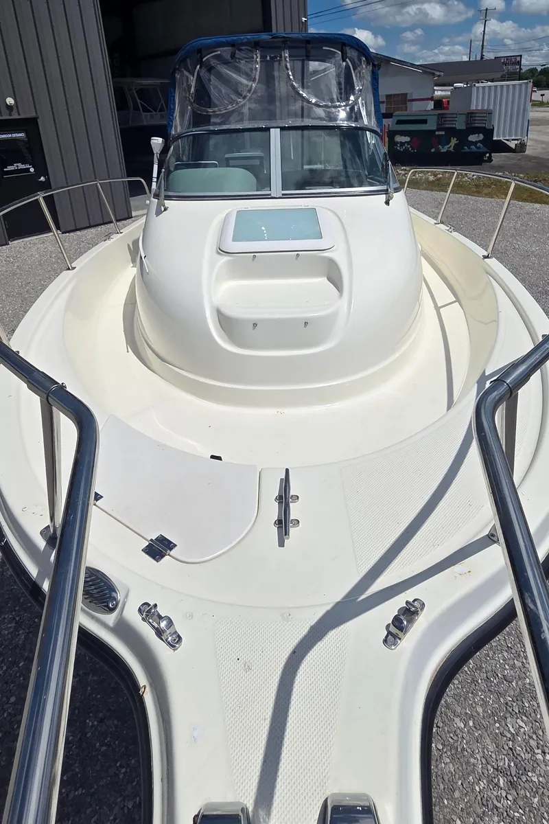 Slide: The Image of 2007 Trophy 2002 Walkaround boat, white deck, docked outdoors under clear sky. - 5