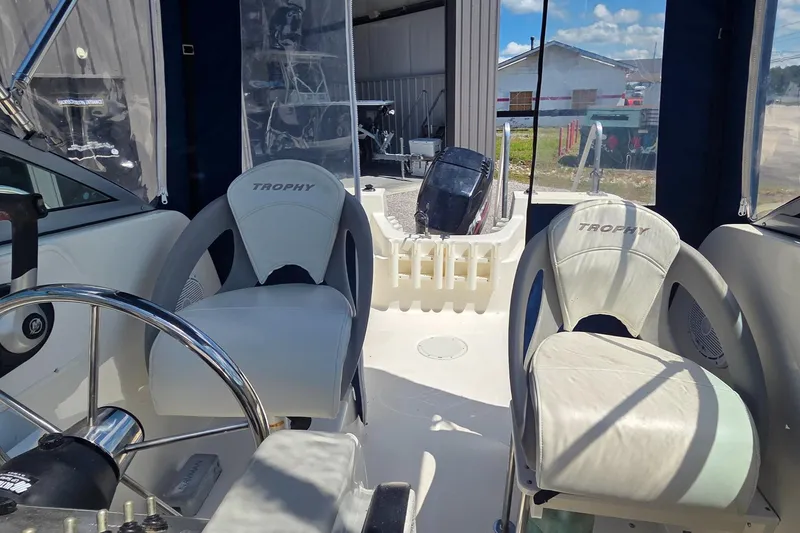 Slide: The Image of Interior of a 2007 Trophy 2002 Walkaround boat with seating and steering wheel. - 9