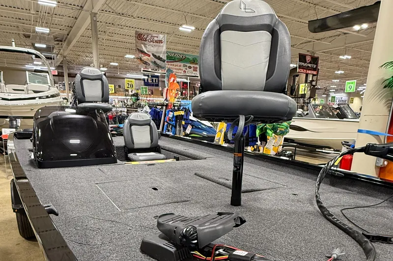 Slide: The Image of 2025 Lowe Legacy boat interior with seating, displayed in a showroom. - 5