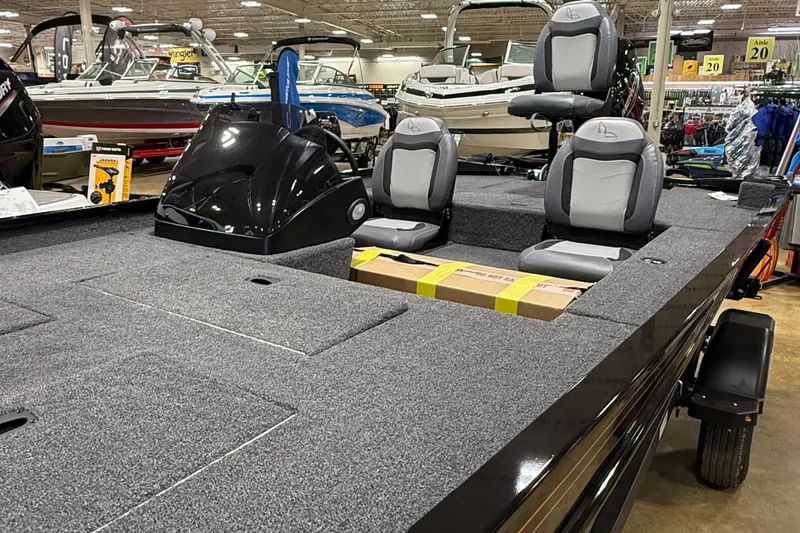 Slide: The Image of 2025 Lowe Legacy boat with gray seating and spacious deck in showroom. - 7