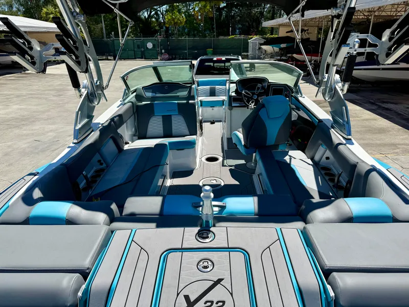 Slide: The Image of 2019 MasterCraft X22 boat interior with blue and gray seating, showcasing luxury and comfort. - 3