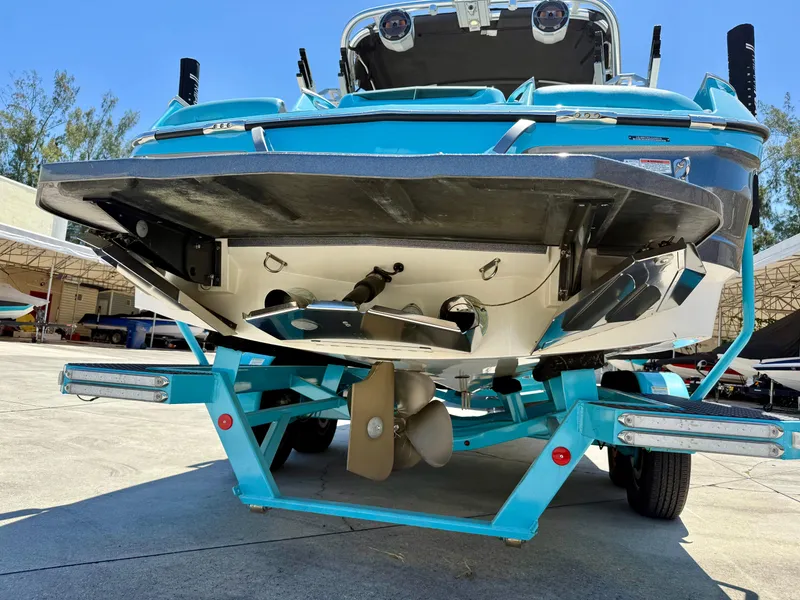 Slide: The Image of 2019 MasterCraft X22 boat on trailer, rear view, showcasing propeller and hull design. - 4