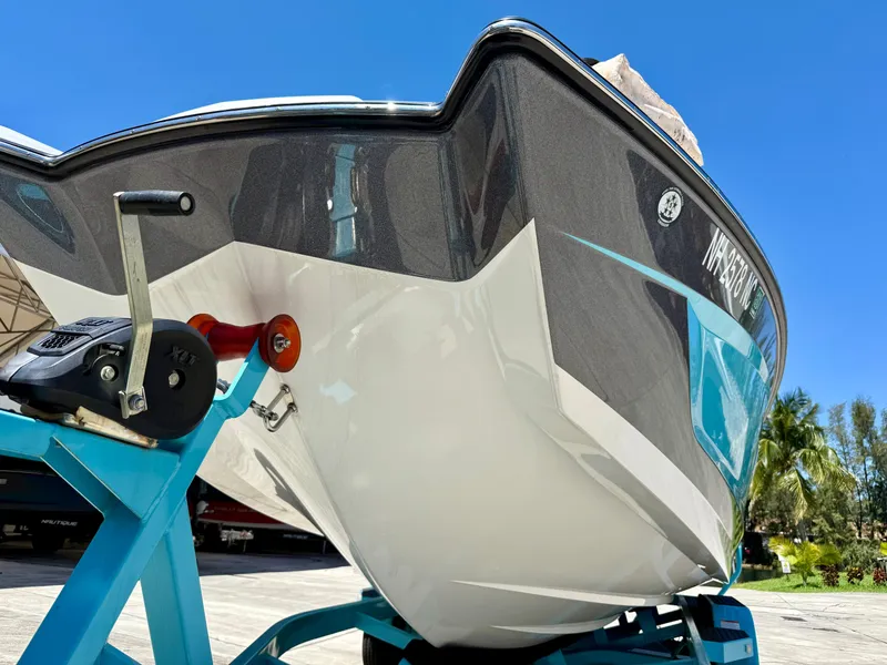 Slide: The Image of 2019 MasterCraft X22 boat on trailer under clear blue sky. - 5