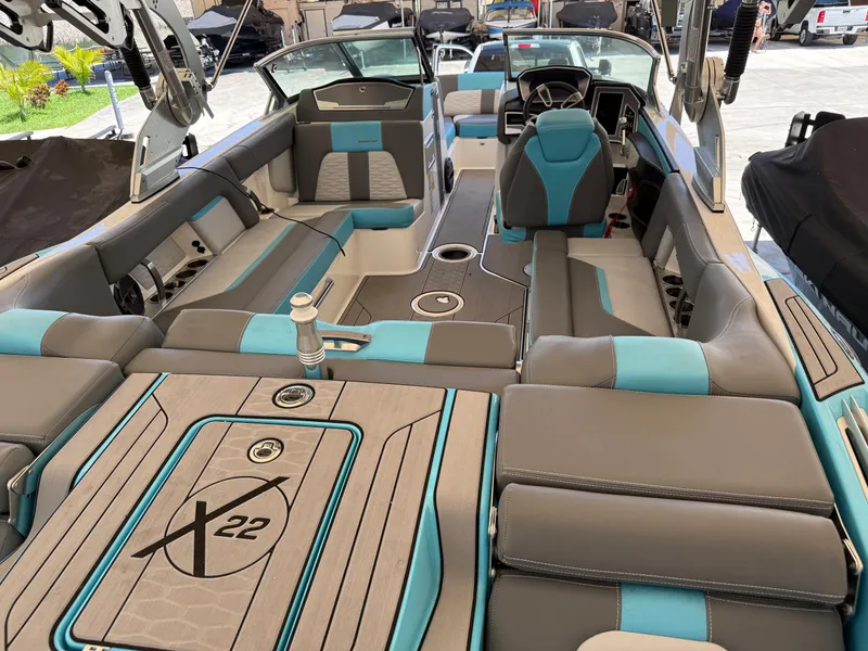 Slide: The Image of 2019 MasterCraft X22 boat interior with gray and blue seating, showcasing luxury and comfort. - 7