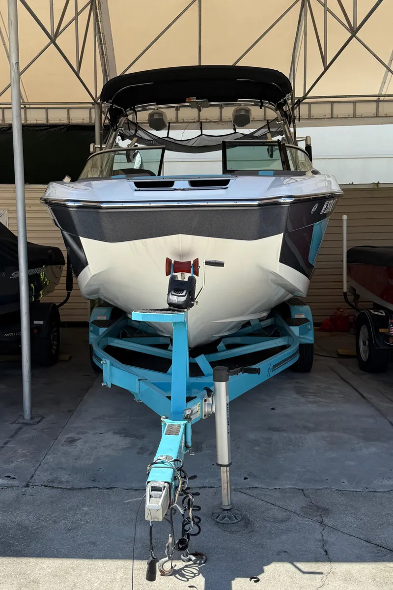 Slide: The Image of 2019 MasterCraft X22 boat on trailer in covered storage area. - 9
