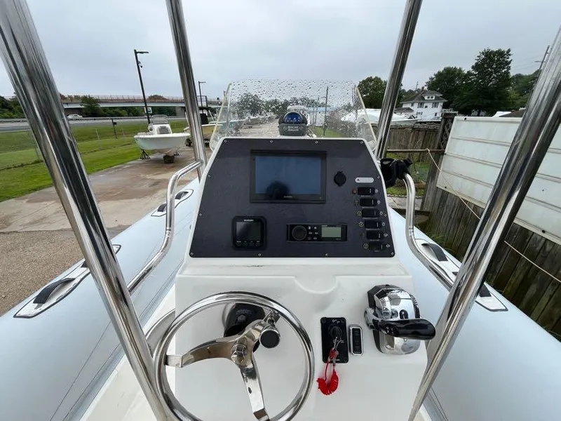 Slide: The Image of 2019 Apex A-24 boat console with steering wheel and navigation controls. - 5