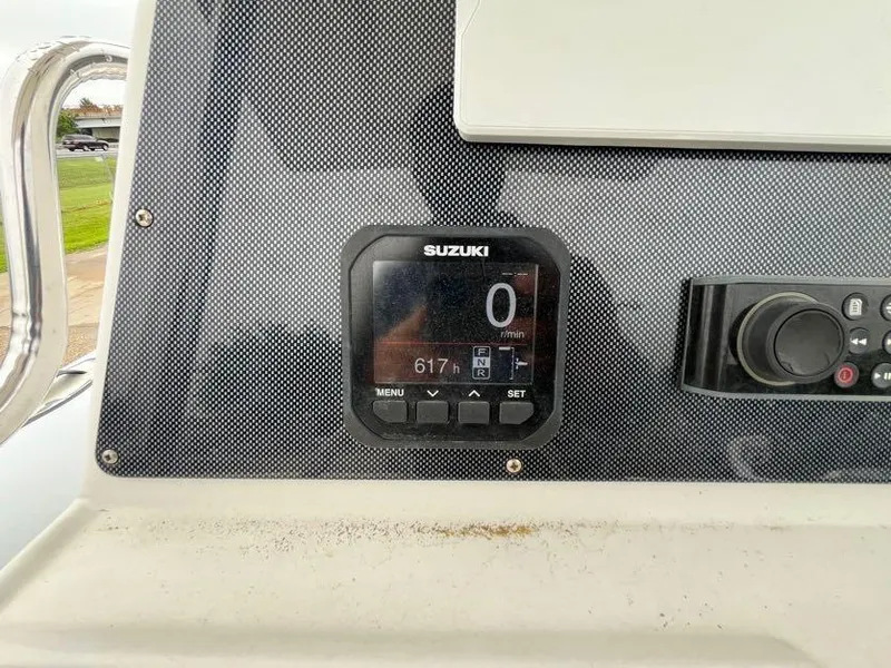 Slide: The Image of Dashboard of a 2019 Apex A-24 boat featuring a Suzuki digital display. - 6