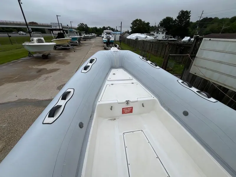 Slide: The Image of 2019 Apex A-24 inflatable boat on display at a marina. - 7