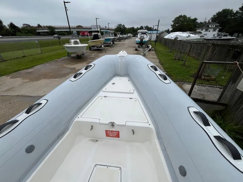 Slide: The Image of 2019 Apex A-24 inflatable boat on display at a marina. - 8