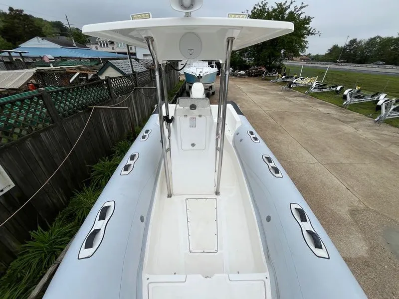 Slide: The Image of Apex A-24 boat, 2019 model, docked in a marina with overcast skies. - 9