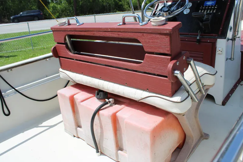 Slide: The Image of 1982 Boston Whaler 17 Montauk interior with red seat and fuel tank. - 13