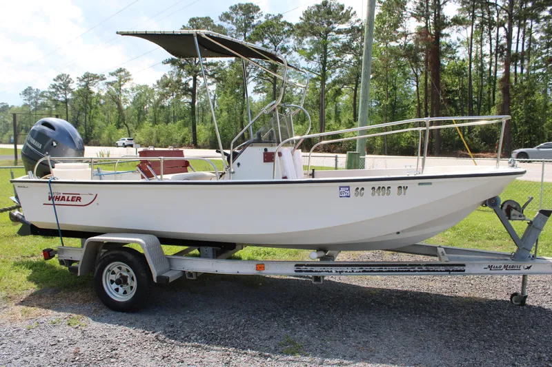 Slide: The Image of 1982 Boston Whaler 17 Montauk boat on trailer, parked outdoors. - 14