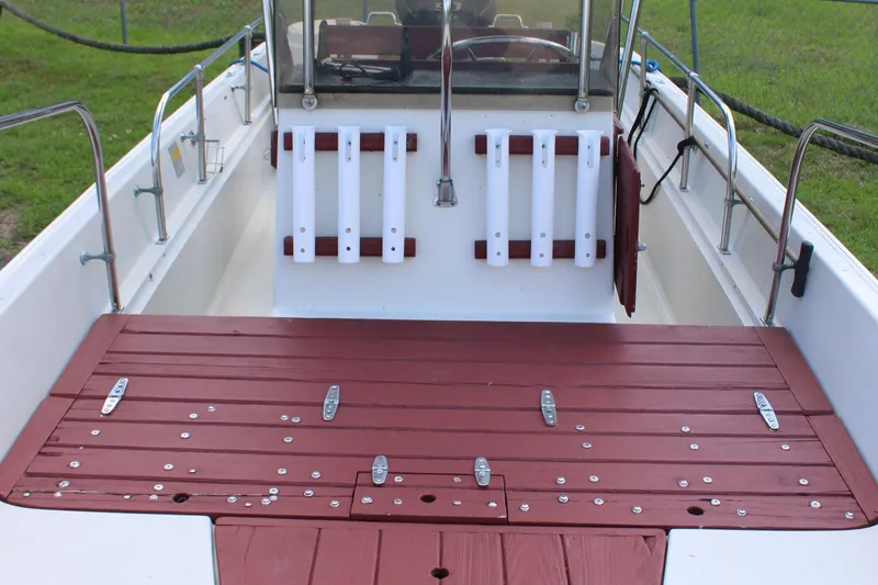 Slide: The Image of 1982 Boston Whaler 17 Montauk interior with red deck and white rod holders. - 15