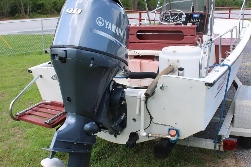 Slide: The Image of 1982 Boston Whaler 17 Montauk with Yamaha 90 outboard motor on a trailer. - 16