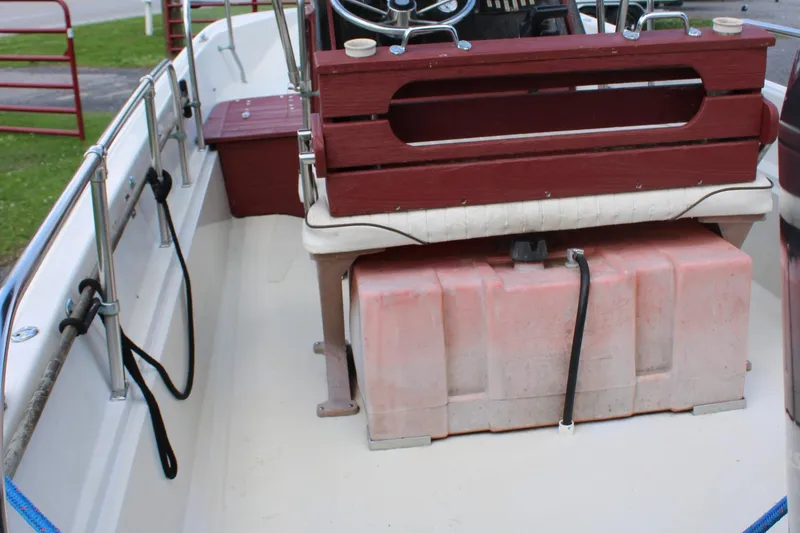 Slide: The Image of 1982 Boston Whaler 17 Montauk interior with red seating and fuel tank. - 17