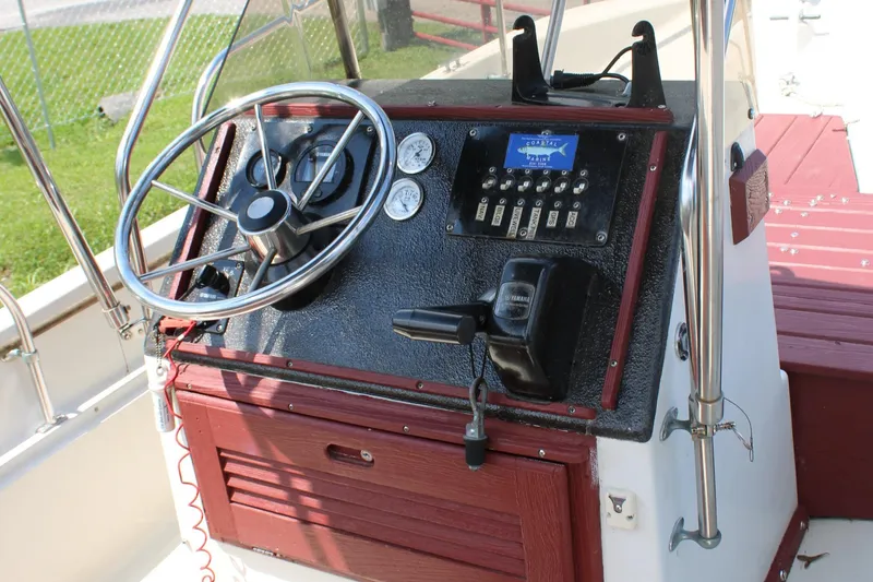Slide: The Image of 1982 Boston Whaler 17 Montauk boat console with steering wheel and control panel. - 19