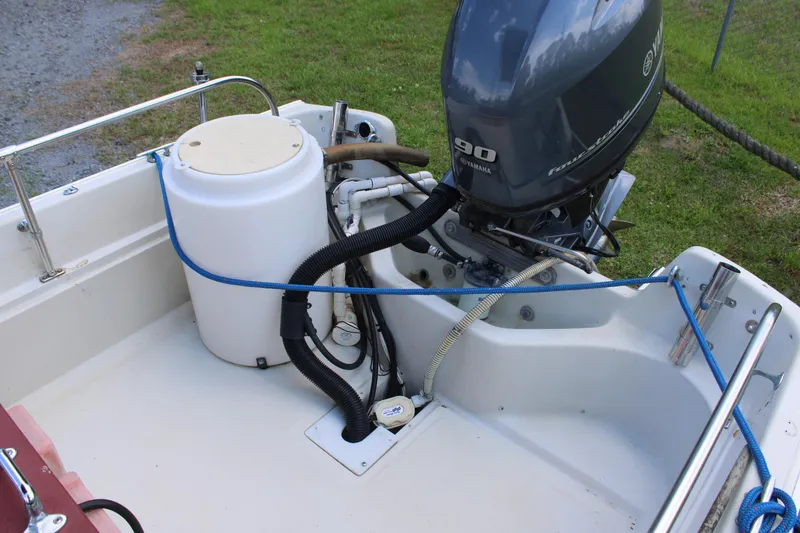 Slide: The Image of 1982 Boston Whaler 17 Montauk boat engine and deck details, featuring a 90 horsepower motor. - 3