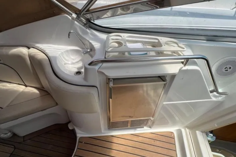 Slide: The Image of 2004 Chris-Craft 33 Express boat interior with sink, seating, and wooden flooring. - 10
